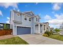 Lovely two-story home with a blue exterior, attached garage, and a welcoming covered front porch at 713 San Juan Dr, Lafayette, CO 80026