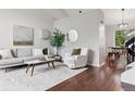 Bright living room features hardwood floors, high ceilings, and a neutral color palette at 6342 Marshall St, Arvada, CO 80003