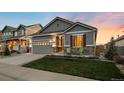 Inviting single-story home features a two-car garage, stone accents, and a lovely front yard at 8048 Grady Cir, Castle Rock, CO 80108