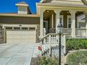 Inviting home exterior with a stone-accented garage and a cozy, covered front porch entrance at 15347 Quince Cir, Thornton, CO 80602