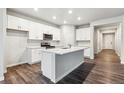 Bright kitchen featuring an island, stainless appliances, and white cabinets at 1464 Orchard St, Brighton, CO 80601