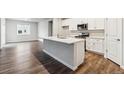 Bright kitchen features an island, stainless appliances, and white cabinets at 1464 Orchard St, Brighton, CO 80601