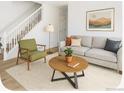 Cozy living room with stylish furnishings, bright walls, and open staircase at 2644 Devonshire Ct, Denver, CO 80229