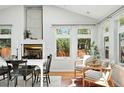 Open dining room featuring hardwood floors, fireplace, and neutral decor at 3608 S Newport Way, Denver, CO 80237