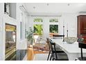 Elegant dining area with modern decor, and views of outdoor greenery at 3608 S Newport Way, Denver, CO 80237