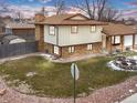 Two-story house with a large backyard, detached shed, and a street view at 1390 E Southern St, Brighton, CO 80601