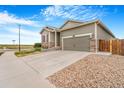 A well-maintained home with a two-car garage and low maintenance landscaping on a sunny day at 581 Park Blvd, Brighton, CO 80603