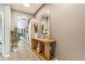 A brightly lit hallway featuring modern decor, wood floors, and neutral wall colors at 581 Park Blvd, Brighton, CO 80603