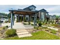 Community outdoor area featuring a covered seating area with bench and landscaped grounds near modern townhomes at 14673 E Belleview Dr, Aurora, CO 80015