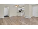 Spacious living room featuring modern flooring and seamless transition to kitchen at 12625 E Pacific Cir # E, Aurora, CO 80014