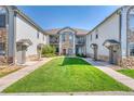 Townhome with a shared green space, multiple balconies and stone accents at 10381 Cook Way # 212, Thornton, CO 80229