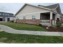 Exterior shot showcasing the well-manicured lawn and walkway leading to the covered porch at 6761 Meade Cir, Westminster, CO 80030