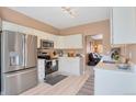 Bright kitchen with stainless steel appliances, white cabinets, and modern countertops at 2673 Live Oak Ct, Castle Rock, CO 80104