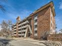 Apartment building with brick exterior, balconies, and street view, providing an urban living experience at 1366 Garfield St # 209, Denver, CO 80206