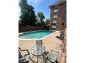 Community pool with lounge chairs and seating area for residents to enjoy the outdoors at 1366 Garfield St # 209, Denver, CO 80206