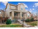 Beautiful two-story home boasting a covered front porch and meticulous landscaping at 376 Dallas St, Denver, CO 80230