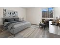 Serene bedroom with a plush bed, modern decor, and a window offering a view of the outdoors at 6495 E Happy Canyon Rd # 158, Denver, CO 80237