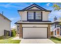 Charming two-story home boasts a well-manicured lawn and attached two car garage at 8827 Cloverleaf Cir, Parker, CO 80134