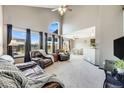 Bright living room with vaulted ceilings, large windows and an open floor plan at 8827 Cloverleaf Cir, Parker, CO 80134