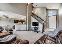Spacious living room featuring vaulted ceilings, a staircase, and an open layout at 8827 Cloverleaf Cir, Parker, CO 80134