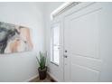 Bright entryway with wood-look floors, featuring a window and a statement art piece at 16130 E 111Th Dr, Commerce City, CO 80022