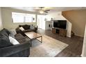 Comfortable living room with ceiling fan and modern decor at 7883 S Kalispell Cir, Englewood, CO 80112