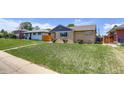 Quaint one-story home with a well-manicured lawn and mature landscaping at 3685 Jasmine St, Denver, CO 80207
