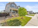 Well-maintained home featuring a cozy front porch and beautifully landscaped front yard at 7018 E 123Rd Pl, Thornton, CO 80602