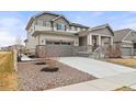 Attractive two-story house boasts a manicured yard with a well-maintained lawn, and a driveway leading to a two-car garage at 17614 Drake St, Broomfield, CO 80023