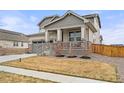 Charming two-story house features a front yard, a side driveway leading to a two-car garage, and a welcoming front porch at 17614 Drake St, Broomfield, CO 80023
