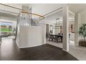 Spacious entryway featuring hardwood floors and staircase, leading to a dining room and living area at 22665 E Calhoun Pl, Aurora, CO 80016