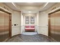 A stylish elevator lobby with seating, decorated walls and access to dual elevators at 975 N Lincoln St # 10A, Denver, CO 80203