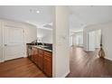 A modern kitchenette with stainless steel appliances, sleek countertops, and dark cabinets at 975 N Lincoln St # 10A, Denver, CO 80203
