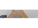 Hallway with hardwood floors and a gray rug, providing a warm welcome at 1345 S Ivy Way, Denver, CO 80224