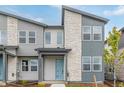 A close-up of a townhome featuring stone accents and a light blue front door at 20530 E 58Th Ave, Aurora, CO 80019
