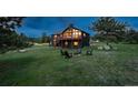 Beautiful two-story home with deck and cozy fire pit on a large grassy lot at 28364 Tresine Dr, Evergreen, CO 80439