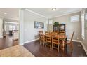 Traditional dining room featuring hardwood floors, elegant furnishings, and ample natural light at 11346 E 27Th Ave, Denver, CO 80238