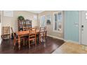 Traditional dining room featuring a wood table, chairs, hutch and natural light from shuttered windows at 11346 E 27Th Ave, Denver, CO 80238