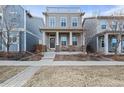 Inviting two-story home featuring a welcoming front porch with seating and well-maintained landscaping at 11346 E 27Th Ave, Denver, CO 80238