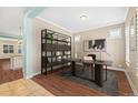 Bright home office featuring built-in shelving, a modern desk, and hardwood floors at 11346 E 27Th Ave, Denver, CO 80238