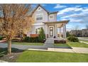 Charming two-story home featuring a covered front porch, a landscaped lawn, and a welcoming entryway at 1950 W 67Th Ave, Denver, CO 80221