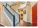 Bright foyer with hardwood floors, staircase, and view of the laundry room at 11522 Pine Grove Ln, Parker, CO 80138