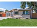 Quaint single-story home featuring a cozy covered entry, complemented by a well-maintained lawn and mature trees at 7391 Dale Ct, Westminster, CO 80030