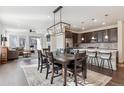 Open concept dining room with a large table and access to the kitchen at 7766 Fraser River Cir, Littleton, CO 80125