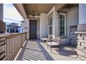 Inviting front porch with seating area and view of the neighborhood at 7766 Fraser River Cir, Littleton, CO 80125