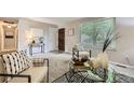 Neutral living area boasts neutral colors and plush carpet with a modern decor and ample natural light at 11617 W 71St Dr, Arvada, CO 80004