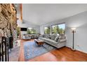 Bright living room featuring hardwood floors, large windows with mountain views, and stylish decor at 29304 Thimbleberry Ln, Evergreen, CO 80439