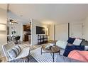 Open-concept living area with a view into the kitchen, dining area, and sliding closet doors at 789 N Clarkson St # 201, Denver, CO 80218