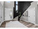 Elegant entryway with black spiral staircase, wood floors, and a bright, airy feel at 6737 S White Crow Way, Aurora, CO 80016