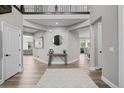 Open entryway with wood floors, neutral colors, a decorative table and mirror at 6737 S White Crow Way, Aurora, CO 80016